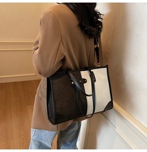 Detail of color-block tote bag with suede and canvas panels and black leather handles
