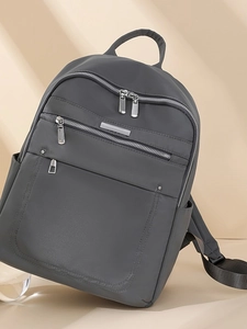 Waterproof dark grey nylon backpack for women featuring multi-zipper pockets and minimalist design