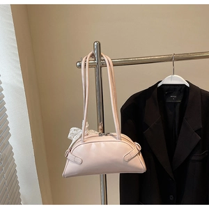 Detail of light pink crescent bowling bag with lace bow accessory on metal hanger