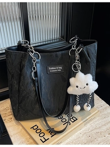 Large black textured leather tote bag with silver chain straps and a cute cloud charm