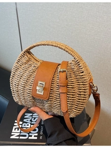 French style woven straw half-moon crossbody bag with brown leather flap and metal lock