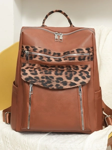Brown faux leather leopard print backpack with multiple zippers and side pockets