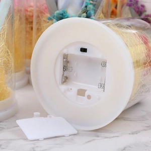 Detail of white light base with LED wires and battery compartment for eternal flowers