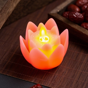 Buddhist lotus LED electronic candle lamp with flickering flame on a bamboo mat
