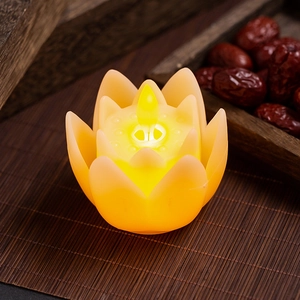 Close-up of a warm yellow LED lotus candle lamp with realistic flickering flame effect