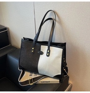 Detail of color-block tote bag with leather straps and wide detachable shoulder strap