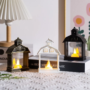 Three decorative LED house lanterns in gold, white, and black with warm candle light