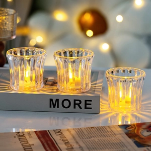 Three-piece set of vertical ribbed glass candle holders with warm LED electronic lights