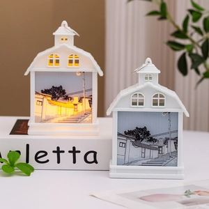 Creative white house night lights with warm glow on decorative books for home decor