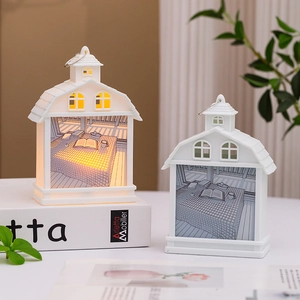Detail of cottage-style night light showing cozy interior illustration and warm LED glow