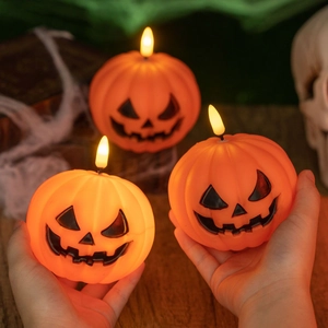 Three-piece glowing orange pumpkin LED candles with Jack-o'-lantern faces for Halloween decor