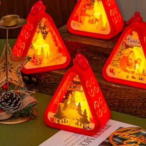 Close-up of red Christmas lantern with Santa patterns and warm LED light effect