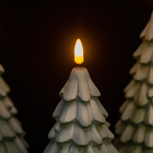 Luminous snow-covered green Christmas tree LED night light with warm orange flame