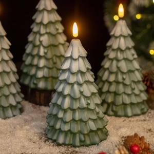 Detail of green LED Christmas tree candles with snow frost effect and warm glowing flame