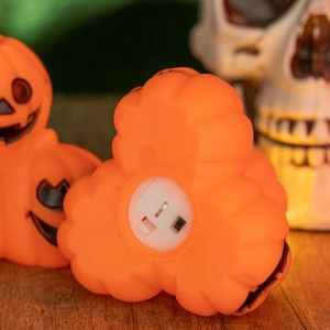 Close-up of the bottom battery compartment and power switch of a Halloween pumpkin light