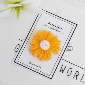 Daisy shaped scented candle in orange with 1 hour burn time for home decor