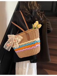 Straw tote bag with colorful stripes and lace flower bow for beach vacation