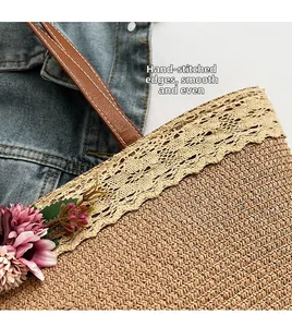Detail of straw tote bag with lace trim, floral accents and stitched leather handle