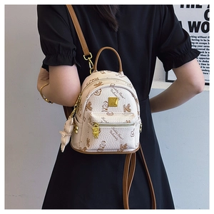 Detailed back view of a mini college style backpack featuring teddy bear prints and gold charms