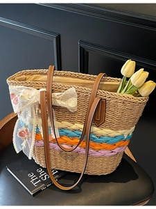 Large straw tote bag with colorful stripes, lace bow embroidery, and leather straps