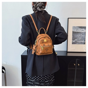 Detail of caramel PU leather backpack featuring KEBU lettering and bear pattern print