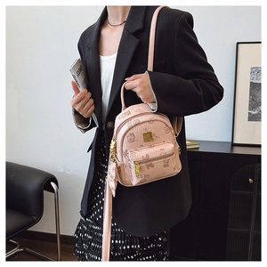Detail of light pink pebbled leather backpack with cartoon bear print and gold zipper