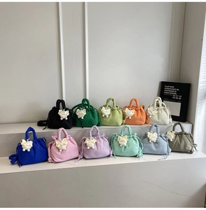 Detailed grid of eleven colorful pleated nylon bucket bags with cute plush charms