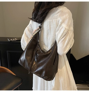 Detail of dark coffee large tote bag with soft pleated leather and a silk scarf