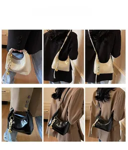 Detail of hobo crossbody bag showing sensjia embossed logo and woven knot charm