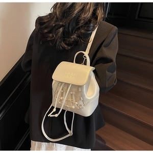 Mini cream PU backpack detail featuring pearl net mesh and AIRM embossed flap on model