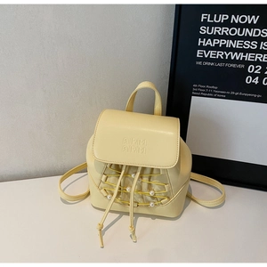 Close-up of cream mini backpack with AIRIMI branding, pearl accents and drawstring detail