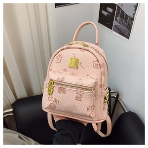 Detail of light pink mini backpack featuring vintage bear prints and golden teddy bear zipper