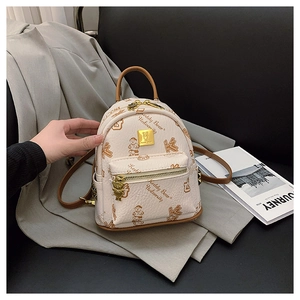 Detail of printed preppy backpack with Teddy Bear University patterns and gold bear zipper