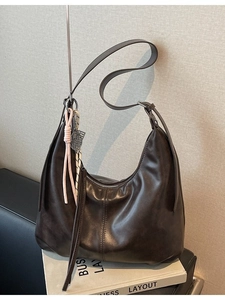 Dark brown Hobo bag with large capacity, adjustable strap and decorative pendant detail