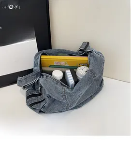Macro shot showing the spacious interior of a blue washed denim bag with large capacity