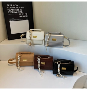 Detail shot of stylish square handbags in five colors on a tiered minimalist display