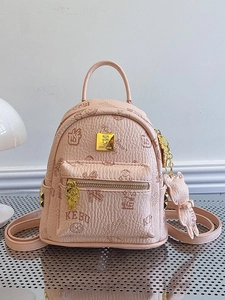 Pink mini backpack with teddy bear prints and metal charms on a neutral background