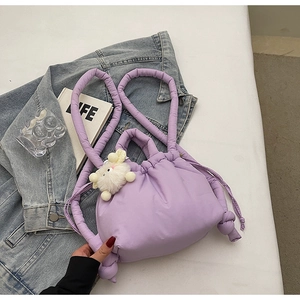 Detail of purple quilted nylon bucket bag with soft drawstring closure and bunny charm