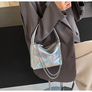 Detail of silver holographic handbag with chain strap and metallic crinkled texture