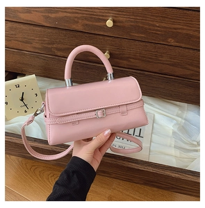 Detail of pink PU leather handbag showing fine texture and silver metal buckle