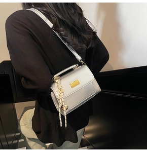Silver mini square crossbody bag on a model showing actual size and metallic finish
