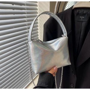 Macro shot of silver holographic pillow bag with laser metal texture and chain strap