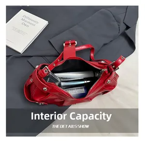 Internal capacity of the red shoulder bag showing spacious interior with cosmetic items