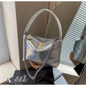 Detail of silver holographic chain handbag with a textured metallic crackle finish