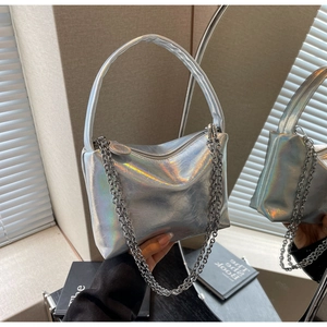 Macro shot of silver holographic pillow bag featuring sleek chain detail and handles