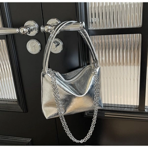 Detail of silver metallic hobo bag with pleated texture and silver chain strap