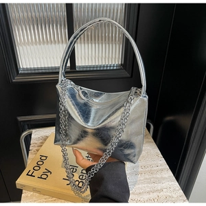 Detail of silver metallic handbag featuring wrinkled texture and elegant chain strap