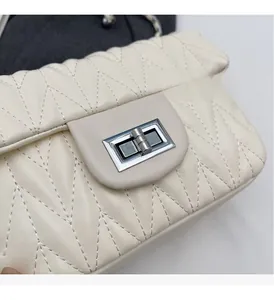 Detail of beige quilted leather shoulder bag with silver square twist lock closure
