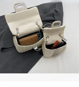 Interior view showing capacity of white quilted chain bags for phone and makeup