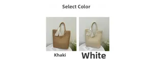 Detail of straw woven tote bags in khaki and white with decorative lace ribbons
